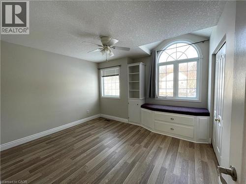 Unfurnished room with a textured ceiling, light wood-style flooring, and ceiling fan - 443 Lausanne Crescent, Waterloo, ON - Indoor Photo Showing Other Room
