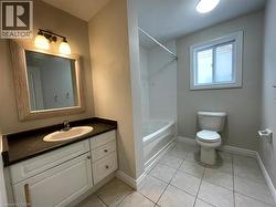 Full bathroom with vanity,  shower combination, and light tile patterned flooring - 