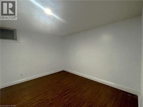 Empty room with baseboards and dark wood-style flooring - 443 Lausanne Crescent, Waterloo, ON - Indoor Photo Showing Other Room
