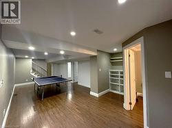 Recreation room featuring recessed lighting and dark wood-type flooring - 