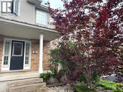 Doorway to property featuring a porch and brick siding - 