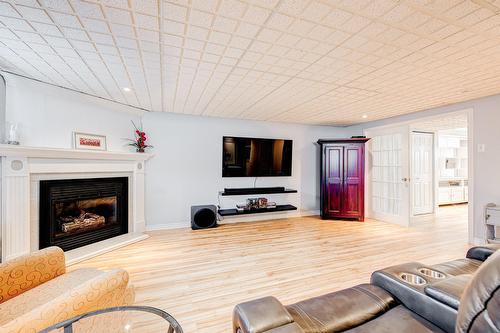 Salle familiale - 87 Rue De Caplan, Blainville, QC - Indoor Photo Showing Living Room With Fireplace
