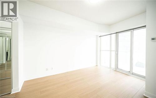 Empty room featuring light wood-type flooring - 50 Absolute Avenue Unit# 2105, Mississauga, ON - Indoor Photo Showing Other Room