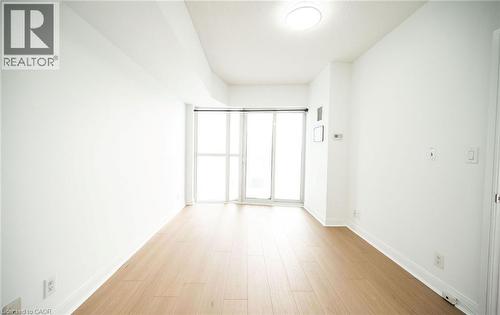 Empty room featuring baseboards and light wood finished floors - 50 Absolute Avenue Unit# 2105, Mississauga, ON - Indoor Photo Showing Other Room
