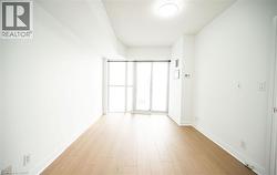 Empty room featuring baseboards and light wood finished floors - 