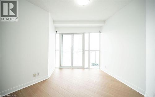 Spare room featuring light wood-style flooring and baseboards - 50 Absolute Avenue Unit# 2105, Mississauga, ON - Indoor Photo Showing Other Room