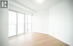 Unfurnished room with light wood-style flooring and baseboards - 