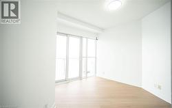 Empty room with light wood-style flooring and baseboards - 