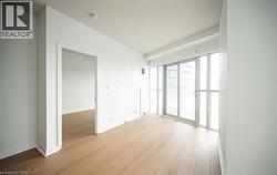Spare room featuring light wood-type flooring and a textured ceiling - 