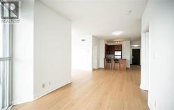 Unfurnished living room with light wood-style floors and baseboards - 