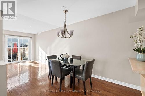 Dining room w chandelier hanging above. - 20 Fieldberry Private, Ottawa, ON - Indoor Photo Showing Dining Room