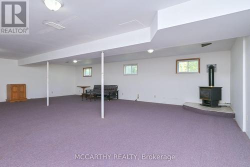 Gas Stove in large Rec Room - 28 Wilson Crescent, Southgate, ON - Indoor Photo Showing Basement