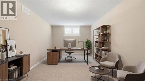 Office space featuring light colored carpet and a textured ceiling - 28 Mansfield Drive, St. George, ON - Indoor