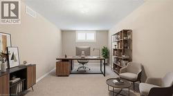 Office space featuring light colored carpet and a textured ceiling - 