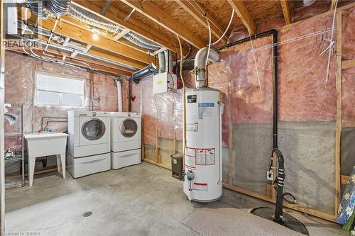 Below grade area with water heater and washer and clothes dryer - 28 Mansfield Drive, St. George, ON - Indoor Photo Showing Laundry Room