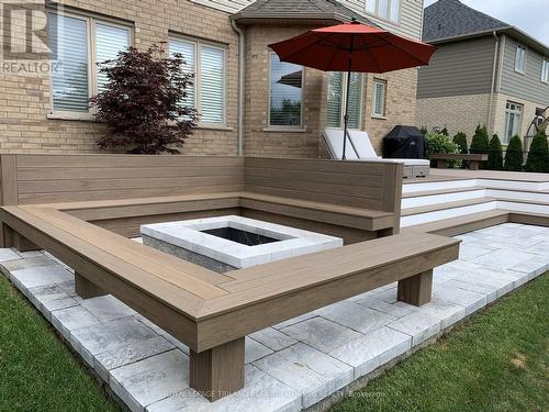 Fire pit with composite bench seating - 2019 - 56 Fieldstone Crescent S, Middlesex Centre (Komoka), ON - Outdoor With Exterior