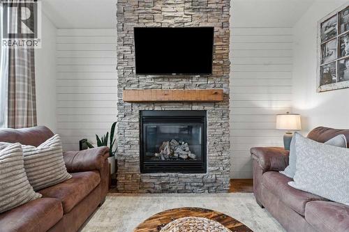 Gas fireplace in living room - 311 Mcleod Crescent, Diamond Valley, AB - Indoor Photo Showing Living Room With Fireplace