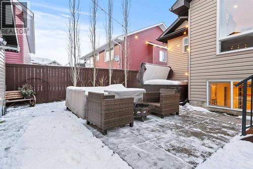 Lower yard with hot tub - 311 Mcleod Crescent, Diamond Valley, AB - Outdoor With Deck Patio Veranda With Exterior