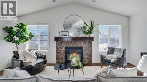 389 Cranberry Circle Se, Calgary, AB - Indoor Photo Showing Living Room With Fireplace