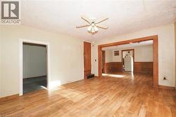 Unfurnished room with wood finished floors and a ceiling fan - 