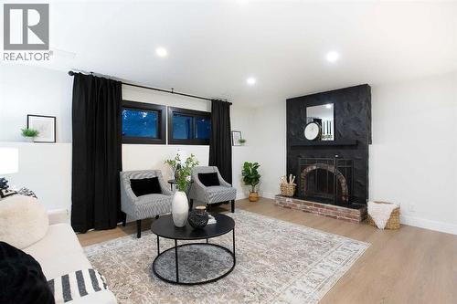 2416 Palliser Drive Sw, Calgary, AB - Indoor Photo Showing Living Room With Fireplace