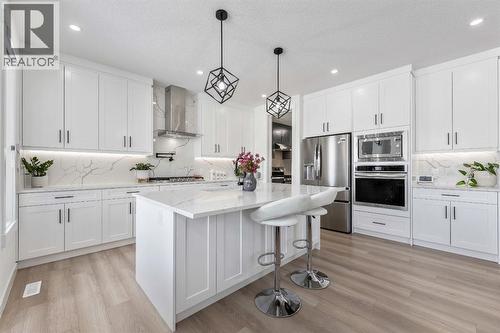 Vinyl Plank Flooring Throughout - 27 Bridges Drive, Langdon, AB - Indoor Photo Showing Kitchen With Stainless Steel Kitchen With Upgraded Kitchen