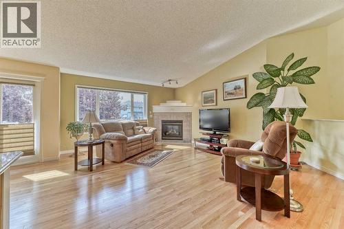 7 Scotia Landing Nw, Calgary, AB - Indoor Photo Showing Living Room With Fireplace