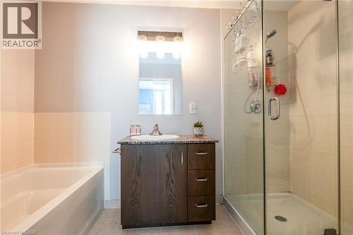 Ensuite with soaker tub and walk-in shower. - 191 King Street S Unit# 702, Waterloo, ON - Indoor Photo Showing Bathroom