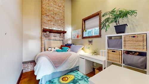 166 304Th Avenue, Kimberley, BC - Indoor Photo Showing Bedroom With Fireplace