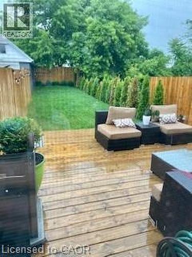 Wooden terrace with a fenced backyard and outdoor lounge area - 22 Mill Street, Hamilton, ON - Outdoor