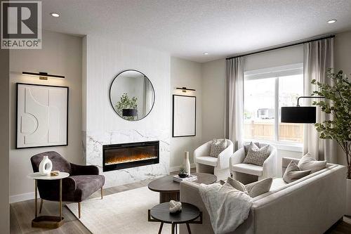17 Amblefield View Nw, Calgary, AB - Indoor Photo Showing Living Room With Fireplace