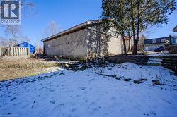 View of snowy exterior featuring concrete block siding - 