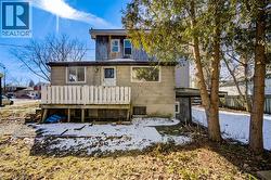 Snow covered back of property featuring a deck - 