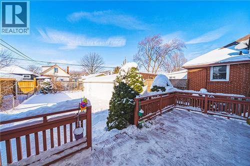 Snow covered deck with a fenced backyard and a residential view - 143 Fairfield Avenue, Hamilton, ON - Outdoor