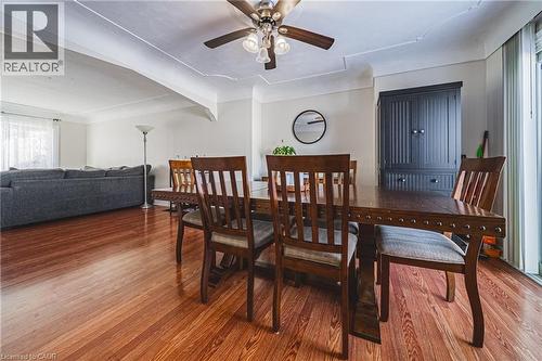 Dining area featuring wood finished floors, beamed ceiling, and a ceiling fan - 143 Fairfield Avenue, Hamilton, ON - Indoor Photo Showing Dining Room