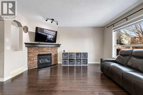 815 Tuscany Drive Nw, Calgary, AB - Indoor Photo Showing Living Room With Fireplace