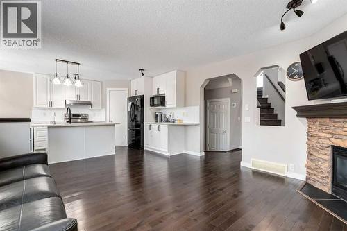 815 Tuscany Drive Nw, Calgary, AB - Indoor Photo Showing Other Room With Fireplace