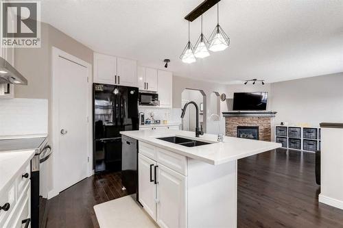 815 Tuscany Drive Nw, Calgary, AB - Indoor Photo Showing Kitchen With Fireplace With Double Sink
