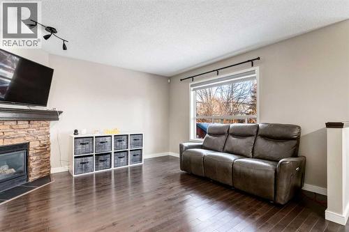 815 Tuscany Drive Nw, Calgary, AB - Indoor Photo Showing Living Room With Fireplace
