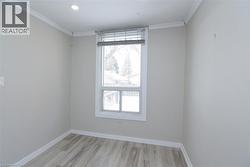 Unfurnished room with ornamental molding and light wood-style flooring - 