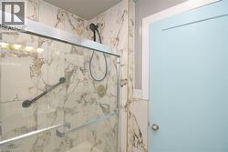 Bathroom featuring bath / shower combo with glass door - 
