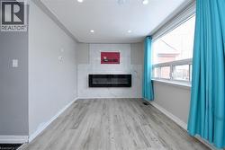 Unfurnished living room featuring a fireplace, light wood-style flooring, and recessed lighting - 