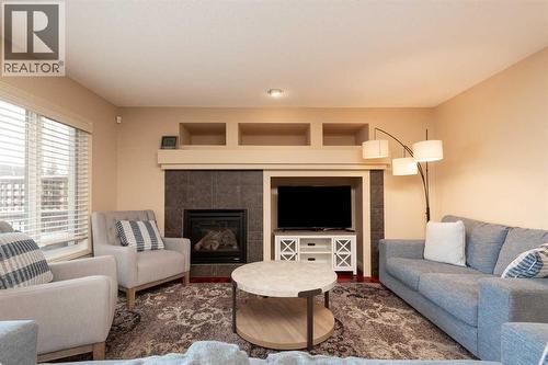 443 Everbrook Way Sw, Calgary, AB - Indoor Photo Showing Living Room With Fireplace