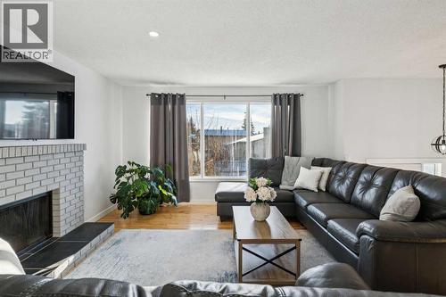 14 Glenhill Crescent, Cochrane, AB - Indoor Photo Showing Living Room With Fireplace