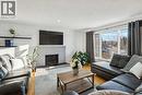 14 Glenhill Crescent, Cochrane, AB  - Indoor Photo Showing Living Room With Fireplace 