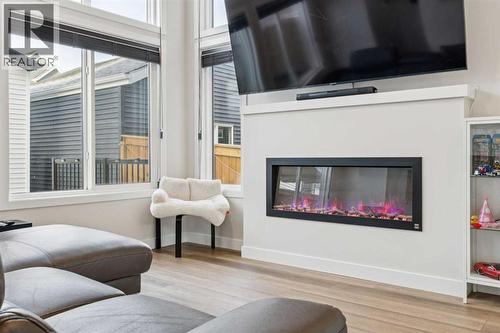 87 Aquila Way Nw, Calgary, AB - Indoor Photo Showing Living Room With Fireplace