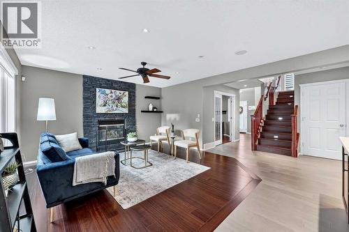 92 Panamount Green Nw, Calgary, AB - Indoor Photo Showing Living Room With Fireplace