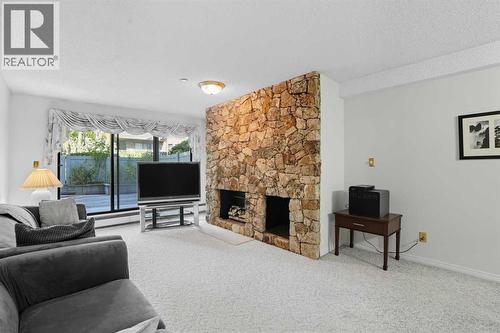 109, 3730 50 Street Nw, Calgary, AB - Indoor Photo Showing Living Room With Fireplace