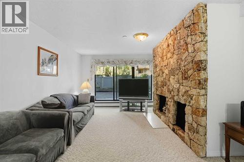 109, 3730 50 Street Nw, Calgary, AB - Indoor Photo Showing Living Room With Fireplace