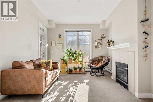 2207, 1888 Signature Park Sw, Calgary, AB - Indoor Photo Showing Living Room With Fireplace